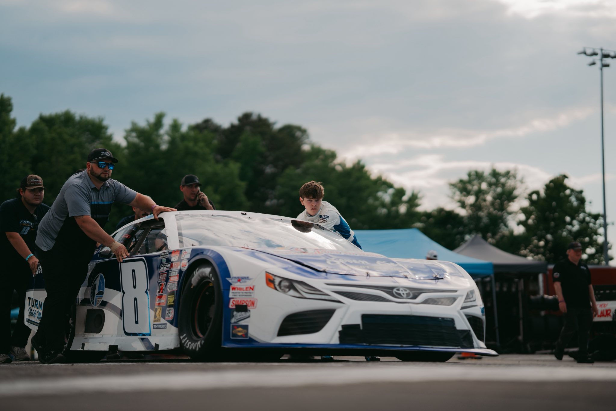 The team pushes the #8 through the paddock